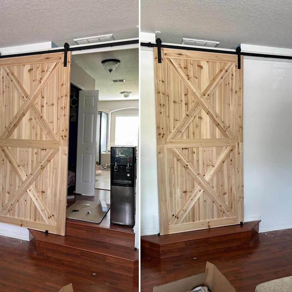 Natural wood double barn doors installed on black sliding hardware