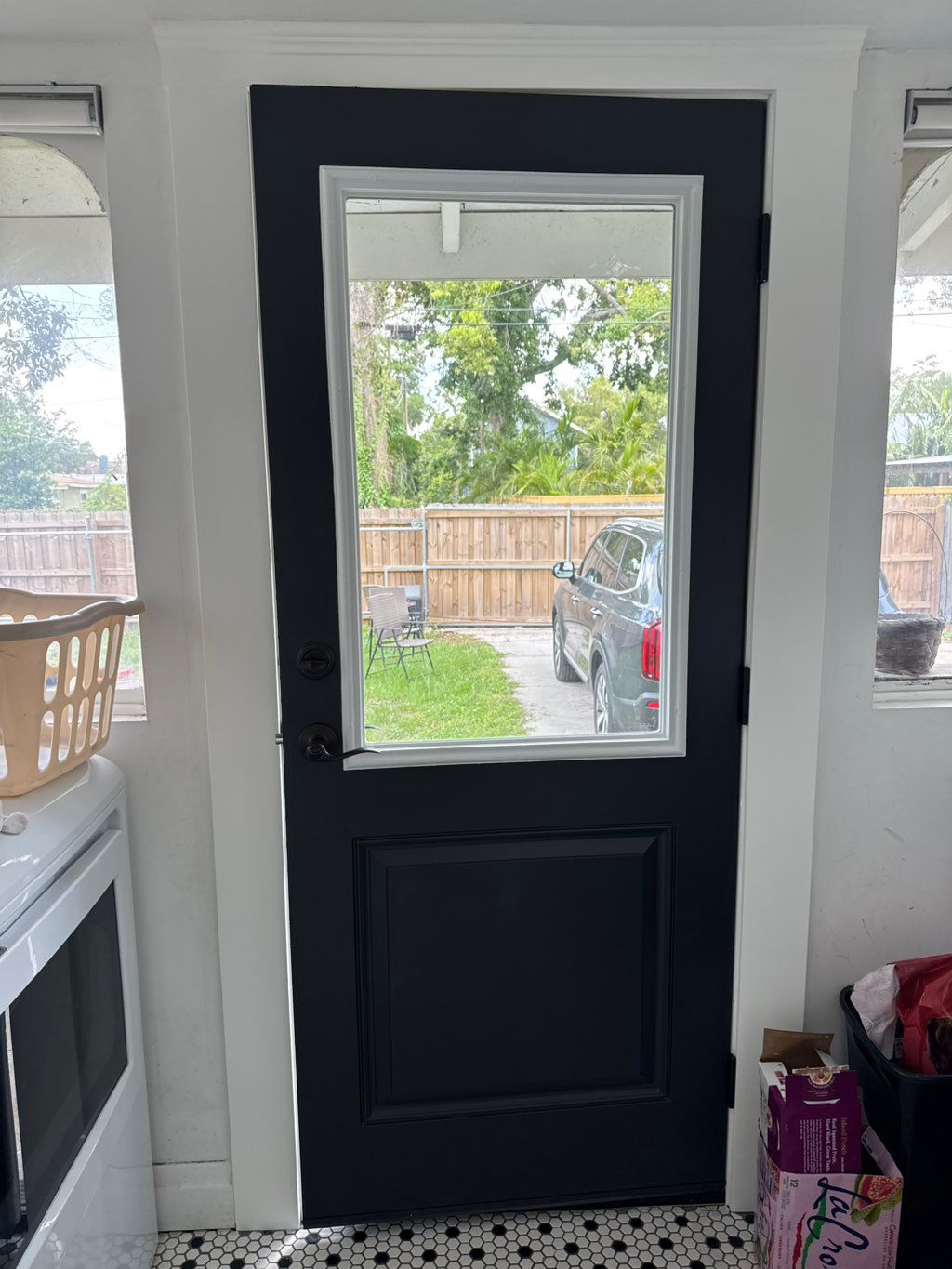 Freshly painted black interior door with clean white trim
